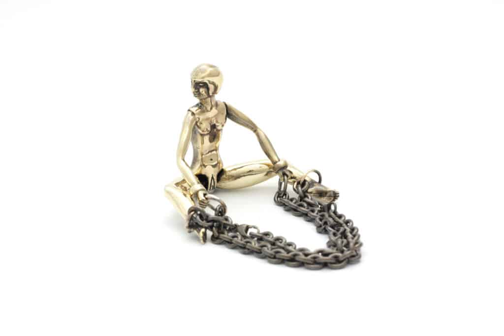 Chain and doll accessory. The different chains encompass a certain part of the sex.