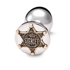 Accesorio plug anal de bronce plateado con decoración de estrella de sheriff dorada.