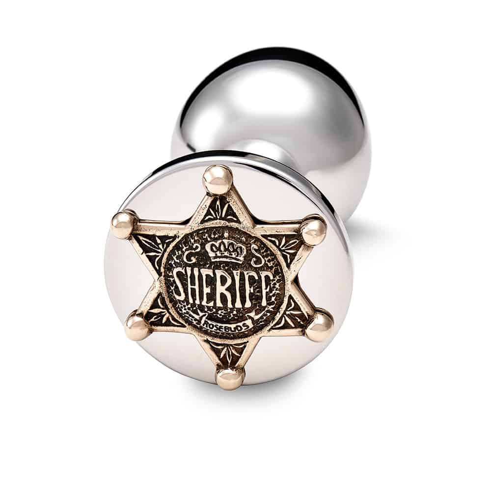 Anal plug accessory in silver bronze and gold sheriff star decoration.