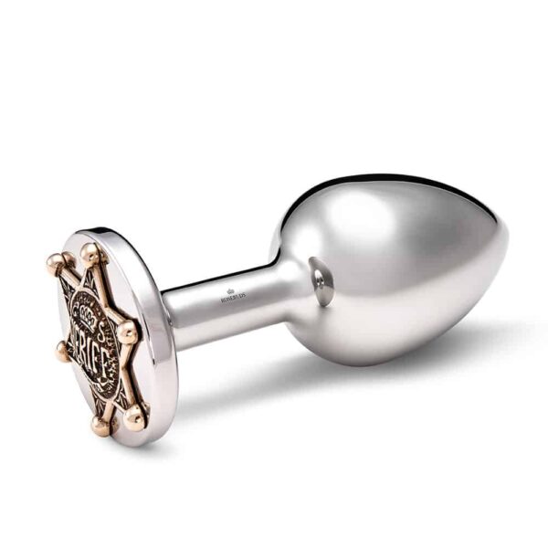 Anal plug accessory in silver bronze and gold sheriff star decoration.