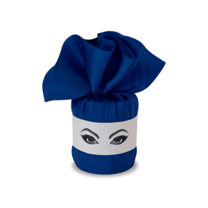 White Chinese porcelain candle wrapped in a blue textile with felt markings of a face with made-up eyes.