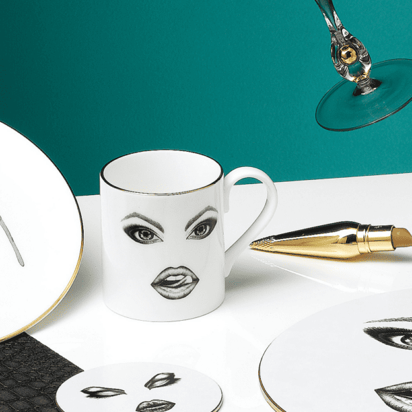 A captivating white porcelain mug, adorned with a precisely drawn monkey in felt. The monkey teases mischievously, running his tongue over his lips. The illustration, done with finesse using a fine-point pen, evokes the Provocateur style and draws its inspiration from Ilona Staller.