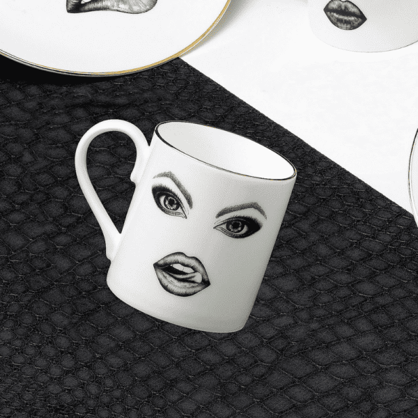 A captivating white porcelain mug, adorned with a precisely drawn monkey in felt. The monkey teases mischievously, running his tongue over his lips. The illustration, finely crafted with a fine-tipped pen, evokes the Provocateur style and draws its inspiration from Ilona Staller.