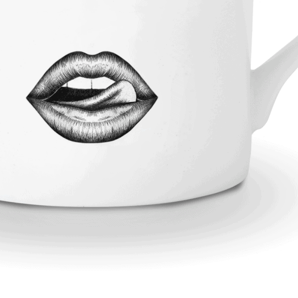A captivating white porcelain mug, adorned with a precisely drawn monkey in felt. The monkey teases mischievously, running his tongue over his lips. The illustration, done with finesse using a fine-point pen, evokes the Provocateur style and draws its inspiration from Ilona Staller.