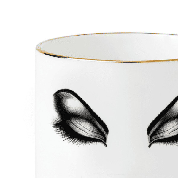 Cup in white Chinese porcelain and precise black felt depicting the prima donna's face in make-up, eyes closed, lips full.