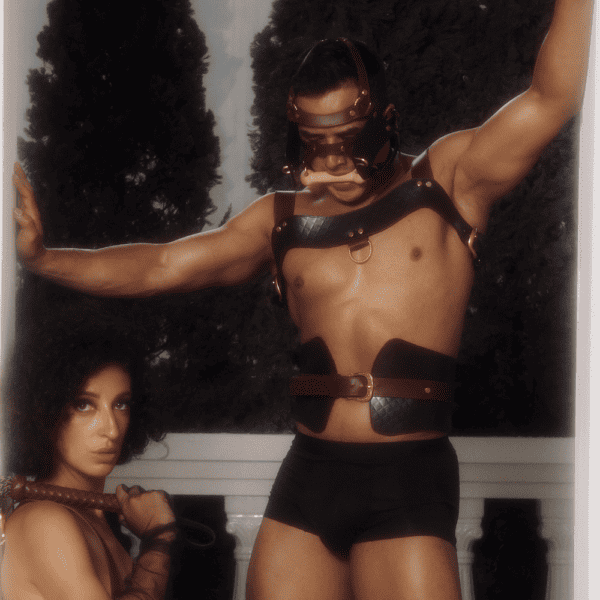 Submissive man gets tortured by his equestrian dominant in brown cowhide lingerie.