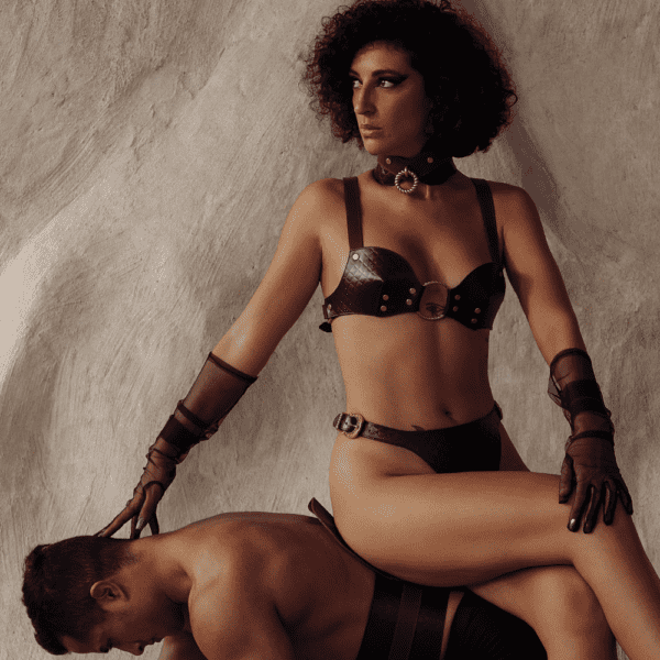 Woman riding on her submissive man in lingerie inspired by equestrian kink