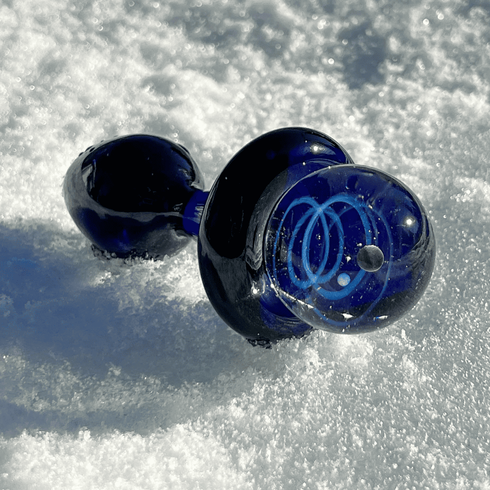 Studio packshot of black galaxy plug on white background, midnight blue with constellations and levitating green planet