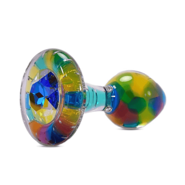 Packshot photograph of a plug on a white background, it is colored with blue, yellow, cyan, light and dark green, pink, purple, a festival of confetti and colors.