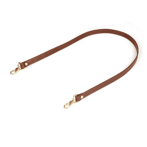 White background photograph of a brown leather saddle clip.