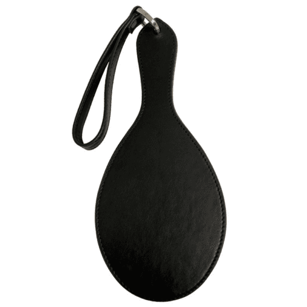 Photograph on white background of the Paddle Fessée Leather in black with gold details