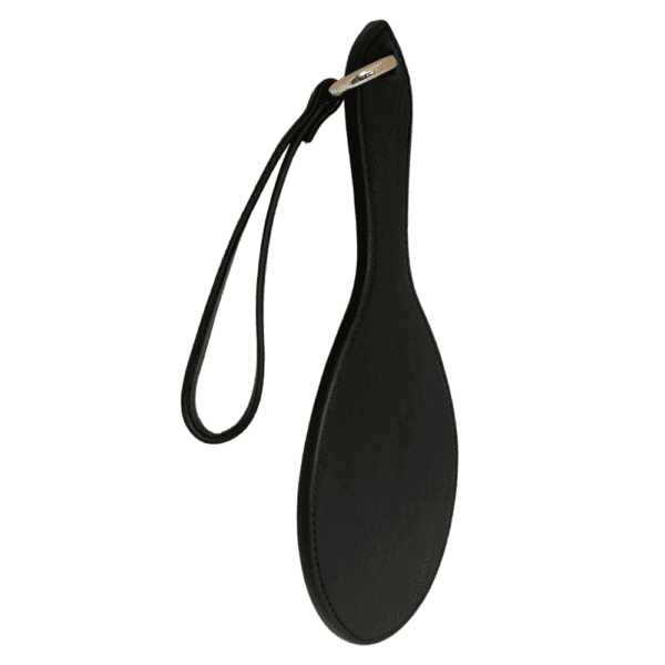 Photograph on white background of the Paddle Fessée Leather in black with gold details