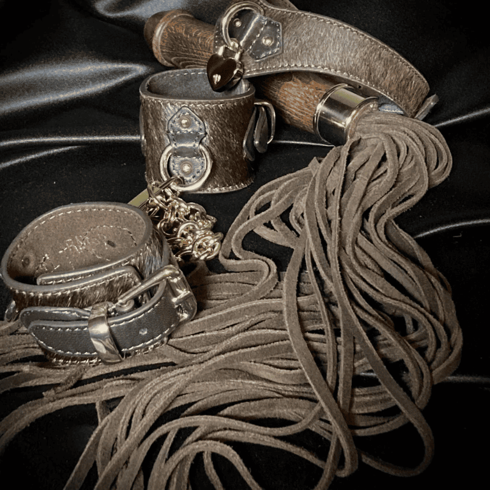 set of brown leather and wood items on a black tablecloth