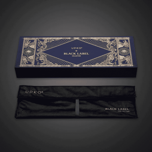 Black background photograph of blue and gold packaging, box with velvet pouch inscribed "UPKO BLACK LABEL COLLECTION".