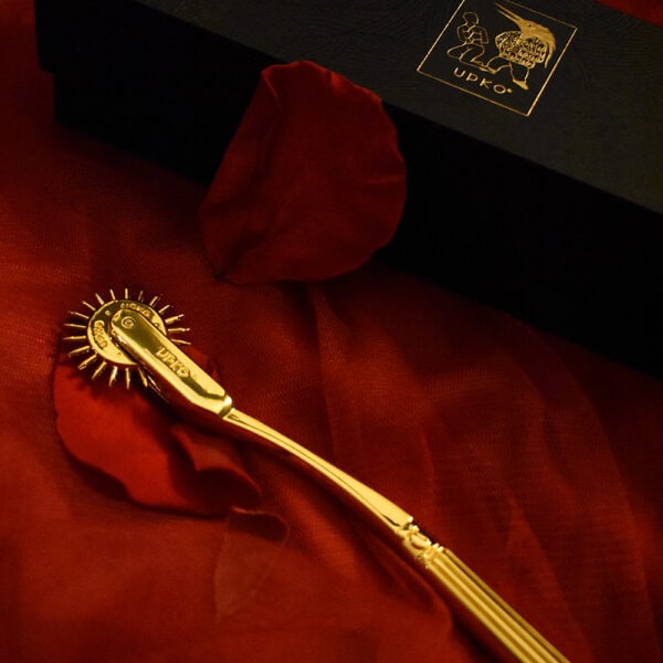 Wartenberg Roulette from UPKO on a red background with red rose petals.