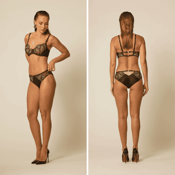 Woman standing front and back wearing the Monarchy bra and Monarchy panties by Vixen & Fox, matched with black pumps. Peacock-inspired collection.