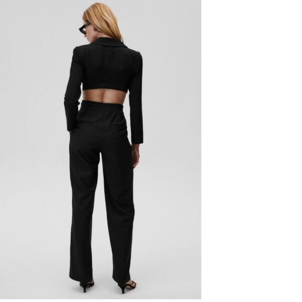 Modelo de espalda que lleva el body Undress Code Obsessed sobre fondo blanco, con pantalones negros.