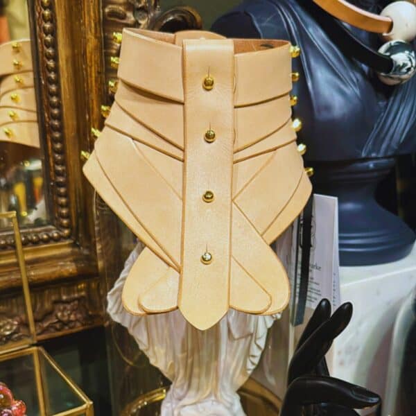 Nude leather collar by Úna Burke, inspired by a medical spine collar, with a bondage rock chic finish. Worn in The Hunger Games - Mockingjay.