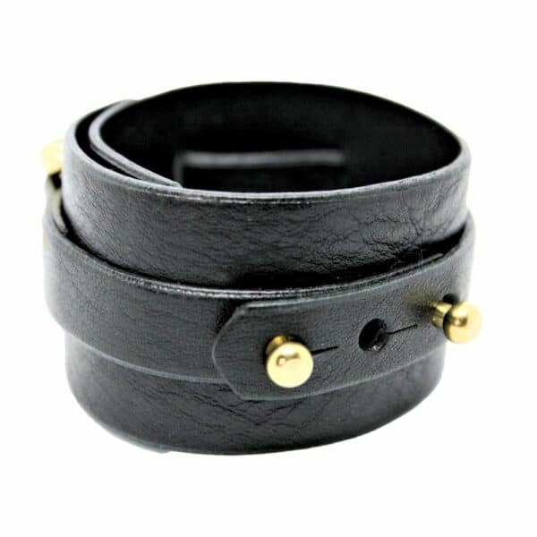 Packshot on white background of Una Burke's black leather wide D stacking cuff.