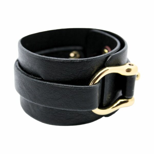 Packshot on white background of Una Burke's black leather wide D stacking cuff.