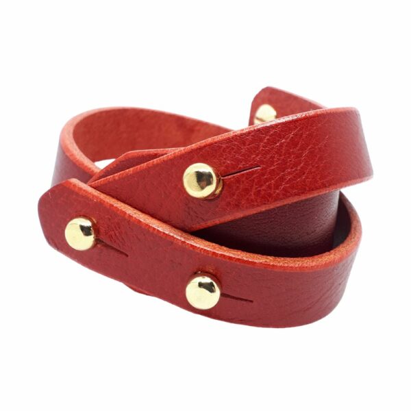Packshot on white background of Una Burke's cherry arch bracelet in red leather.