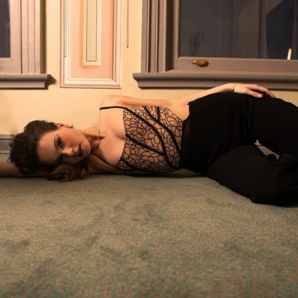 Woman lying on the floor wearing Valnue's Julia bodysuit.