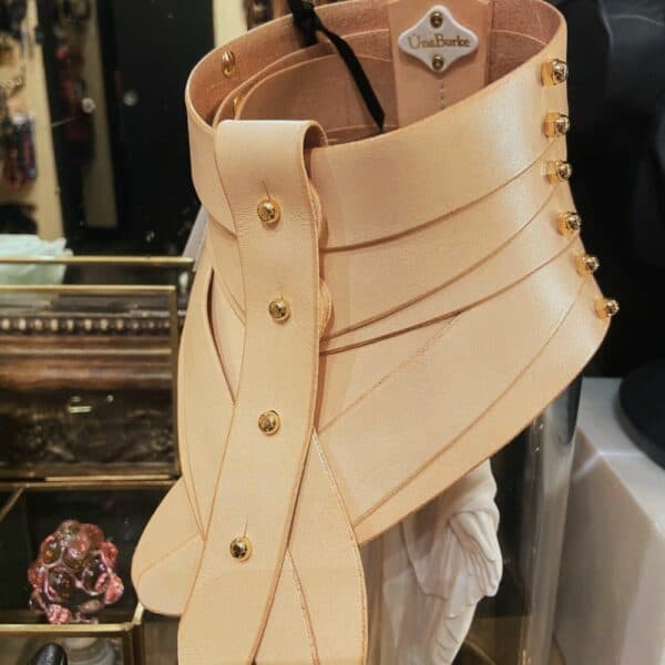Nude leather collar by Úna Burke, inspired by a medical spine collar, with a bondage rock chic finish. Worn in The Hunger Games - Mockingjay.
