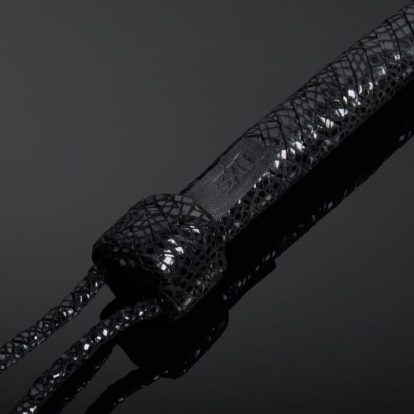 Detail on the Handle of the Packshot Detail of a Leather Whisk Black Color