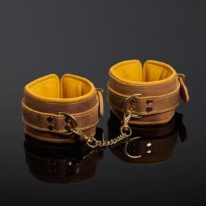 Yellow and brown handcuffs in Italian nubuck leather and gold-plated metal finishes