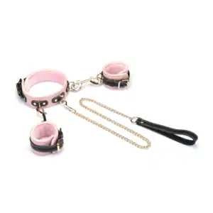 Set collier et menottes LIEBE SEELE en cuir de vache italien rose pâle, noir et doré, reliés par une chaîne dorée. Confort optimal pour les jeux de soumission élégants et raffinés.
