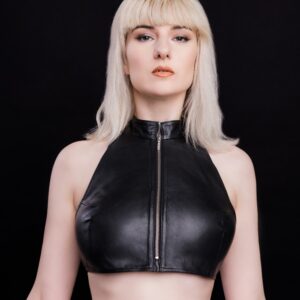 Black sheepskin zipped top with stand-up collar and tie-back, perfect for a bold, sophisticated look.