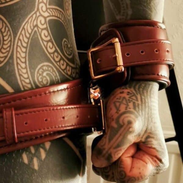 Wine Red Cowhide leather wrist cuffs with rose gold metal D-ring detail and Wine Red cowhide leather thigh cuffs with rose gold D-ring detail