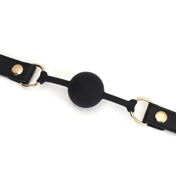 Bâillon Boule GAG en Cuir noir lisse avec boule en silicone sangle réglable détail en métal Doré