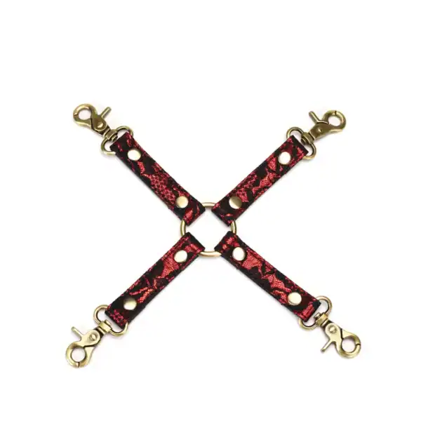 Cross-over hogtie in ruby red imitation leather adorned with black lace and gold metal details
