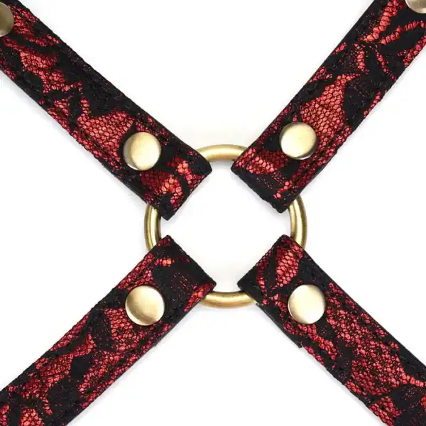 Cross-over hogtie in ruby red imitation leather adorned with black lace and gold metal details